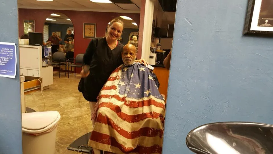 A young customer in a stars-and-stripes cape at the shop
